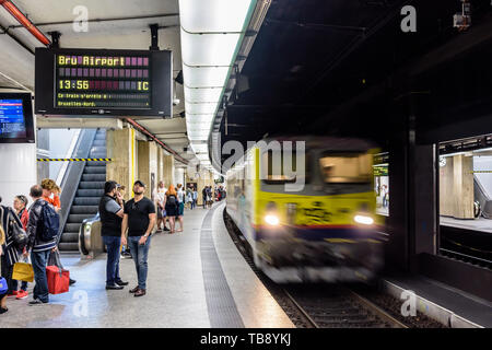 Passagiere warten auf eine U-Plattform in Brüssel Hauptbahnhof als InterCity nach Brüssel Flughafen anreisen. Stockfoto