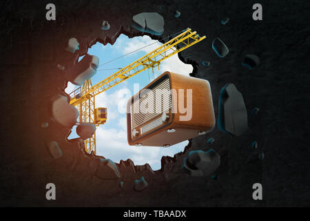 3D-Rendering von baukran Durchführung Retro Radio eingestellt und Stanzen großes Loch in der schwarzen Wand. Stockfoto