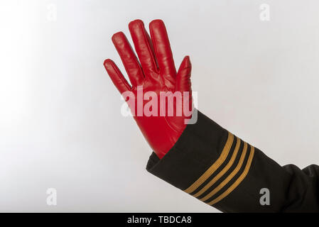 Vier goldene Streifen auf eine einheitliche Jacke mit Händen tragen rote Handschuhe und winken Stockfoto