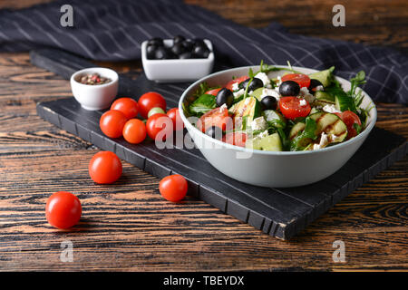 Gesunder Salat mit Feta Käse auf hölzernen Tisch Stockfoto