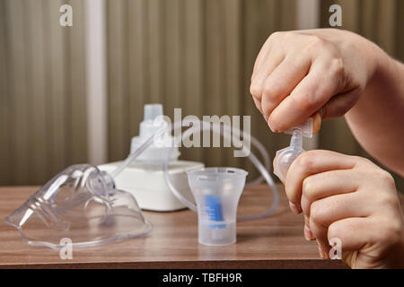 Mischen und die Medizin für Menschen mit Erkrankungen der Atemwege, es gibt Medikamente, Kompressor Vernebler System und vernebelung Rohr auf dem Tisch. Stockfoto