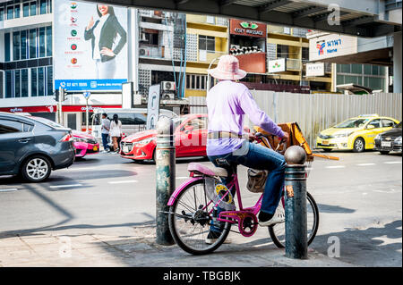 Ein lotterielos Verkäufer reisen durch Bangkok auf seinem Fahrrad Verkauf von Tickets an der Sukhumvit Rd. Thailand. Stockfoto