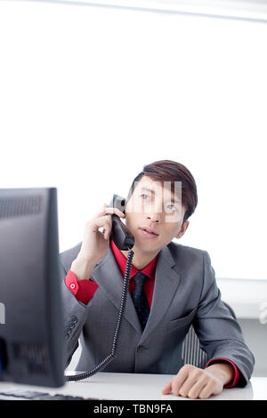 Ein Angestellter ist beschäftigt bei der Arbeit im Büro. Stockfoto