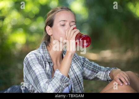 Junge weibliche Wanderer eine Pause für einen Drink Stockfoto