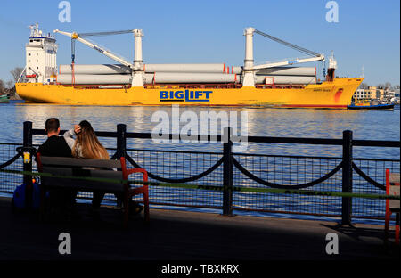 Ein junges Paar entspannende am Ufer des Duluth Hafenbecken mit einem Schiff durch im Hintergrund.. USA Minnesota Duluth. Stockfoto