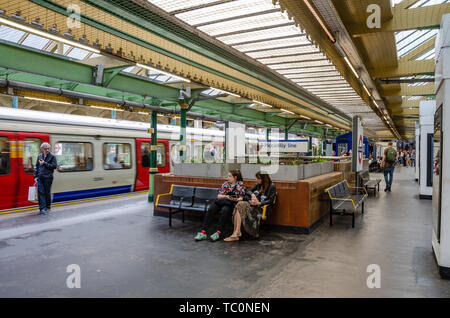 Ein Zug sitzt an der Plattform in der Londoner U-Bahnstation South Kensington. Stockfoto