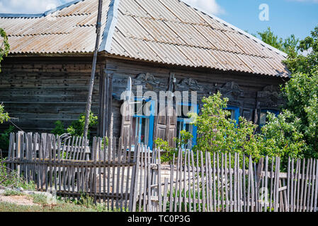 Ansicht der alten Holzhaus im Sommer im Land mit einer Satellitenschüssel Stockfoto
