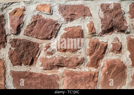 Red stone wall Oberflächenstruktur Stockfoto