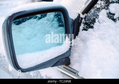 Schneefall. Schnee stecken auf Spiegel des Autos Stockfoto