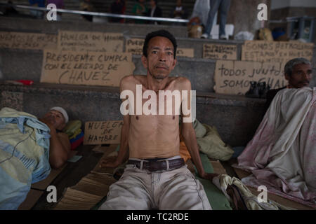 04. Juni 2019, Venezuela, Caracas: Ein Mann ist in einem Camp, wo ehemalige Ölarbeiter Aufmerksamkeit sind mit einem Hungerstreik sitzen. Einige Männer haben im Hungerstreik für sechs Tage. Ehemalige Exxon Mobil Oil Company Arbeiter fordern die Zahlung von Abfindungen und Sozialabgaben nach der Verstaatlichung der US Oil Company Projekt in Venezuela. "Präsident Maduro und seine Minister wird sicherlich drei Mahlzeiten am Tag in Ruhe essen. Er auch an uns denken [.], unserer legitimen Forderung sollte", sagt der 60-jährige Humberto Cifontes. Foto: Rafael Hernandez/dpa Stockfoto