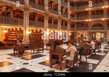 Schrägansicht der Gönner an Bücher suchen im Erdgeschoss des George Peabody Library an der Johns Hopkins Universität, Baltimore, Maryland, 11. Juni 2004. Vom Homewood Sammlung Fotografie. () Stockfoto