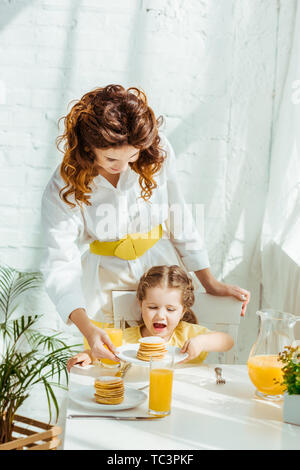 Mutter und Tochter aufgeregt Pfannkuchen zum Frühstück Stockfoto