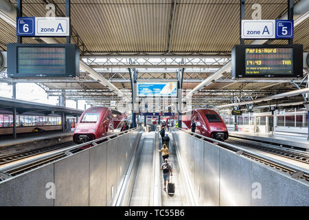 Passagiere ziehen ihre Koffer auf einen Bürgersteig zu Brett auf zwei Thalys Hochgeschwindigkeitszüge in Brüsseler Südbahnhof in Belgien. Stockfoto