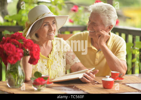 Portrait von Happy senior Paar lesen Buch beim Trinken von Kaffee Stockfoto