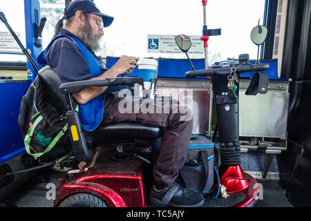 Miami Beach, Florida, Miami-Dade Metrobus, öffentlicher Nahverkehr, innen, elektrischer Rollstuhl, behindert, Erwachsene Erwachsene, Männer, ri Stockfoto