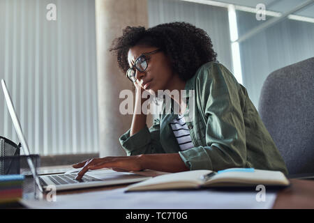 Sorgen junge geschäftsfrau mit Laptop im Büro Schreibtisch Stockfoto