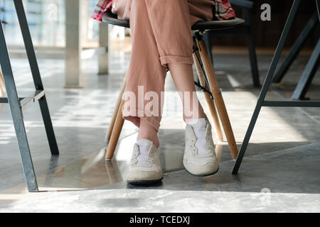 Mädchen teenager Freunde Beine tragen weiße Sneakers im Cafe Café sitzen Stockfoto