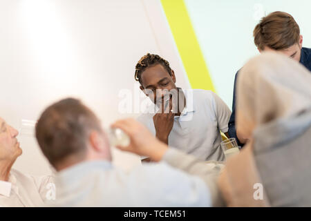 African American man Iftar gemeinsam das Abendessen genießen mit modernen multiethnischen muslimische Familie während des Ramadan Fest zu Hause Stockfoto