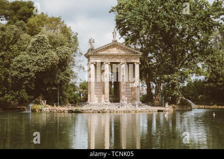 Panoramablick auf den Tempel des Asklepios (Tempio di Esculapio) und See in den öffentlichen Park der Villa Borghese. Tag Sommer und blauer Himmel Stockfoto