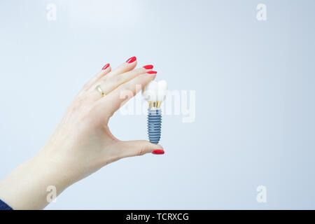 Weibliche hand Zahn falschen Zahn auf weißem Hintergrund Implantat Zahn menschlichen Implantat. Zahnmedizinische Konzept. Menschliche Zähne oder Zahnersatz. Kopieren Sie Raum. Zahnmedizinische Stockfoto