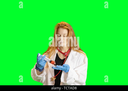 Ingwer behaarte Teen Girl in Laborkittel mit Handschuhen und Stethoskop holding Petrischale von bunten Flüssigkeiten. Stockfoto