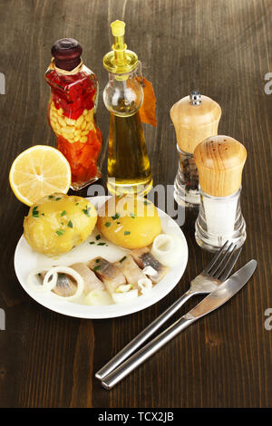 Teller von Hering und Gewürzen auf Holztisch close-up Stockfoto