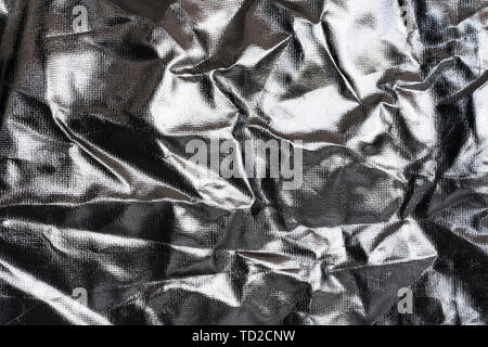 Texturierte Silberfolie Hintergrund mit glänzenden zerknitterten Oberfläche. Stockfoto