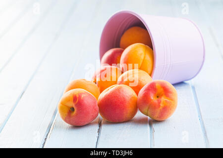 Sweet apricot fruits on blue wooden table. Stockfoto