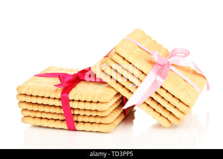 Süße cookies gebunden mit rosafarbenen Bändern isoliert auf weißem Stockfoto