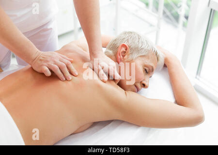 Körper verfahren. Blick von oben auf ein schönes grau behaarte Frau empfangen Körper Massage Stockfoto