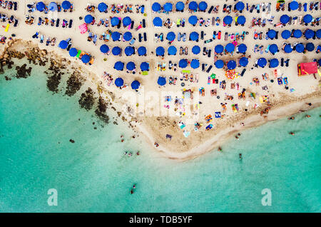 Erstaunlich Luftbild von oben über Nissi Beach in Zypern. Nissi Strand bei Flut. Touristen am Strand entspannen. Überfüllten Strand mit vielen Touristen Stockfoto
