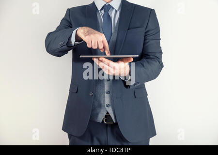 Geschäftsmann, der am Tablet arbeitet. Mann im Anzug Stockfoto