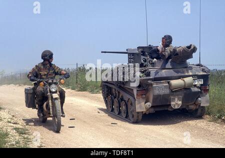 Deutsche Fallschirmjäger light tank Wiesel mit einer belgischen Motorradfahrer im südlichen Italien während NATO AMF (Allied Mobile Force) Übungen Stockfoto