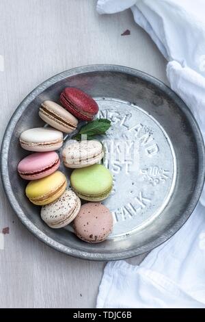 Französische Macarons in verschiedenen Farben serviert auf einem metallischen Silber Platte Stockfoto