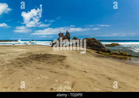 Lange natürliche Strand Benijo mit Spuren im Sand. Lava Rock im Wasser. Blue Sea Horizon, natürliche Himmel Hintergrund. Stockfoto