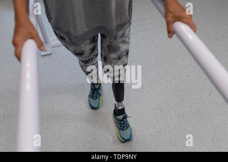 Patientin mit parallel Bars im Krankenhaus Stockfoto