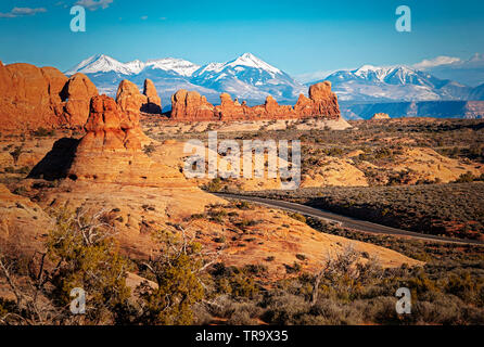 ARCHES NATIONAL PARK LANDSCHAFT MIT DRAMATISCHEN die schneebedeckten Berge in der Ferne Stockfoto