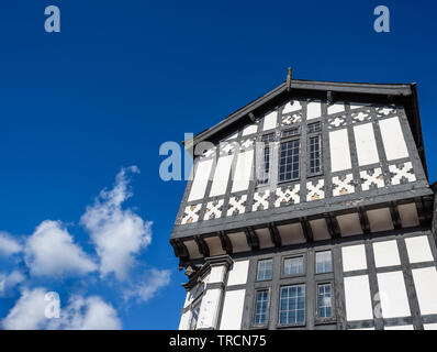 Holz- Schwarz und Weiß mock Tudor Gebäude mit Satteldach Überhang eingerahmt. Stockfoto