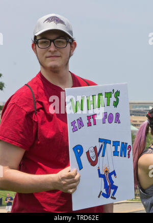 Washington, D.C., USA. 1. Juni 2019. Männliche Demonstrant tragen Baltimore Ravens American Football Team Cap/Hut hält Schild, 'Was ist für Putin?" Mit einer Zeichnung von US-Präsident Donald Trump als der russische Präsident Marionette an der Nationalen März Anzuklagen am Nachmittag des 1. Juni 2019, auf dem Washington Monument in Washington, D.C., USA, durch die Leute verlangen Aktion organisiert. Kay Howell/Alamy Stockfoto