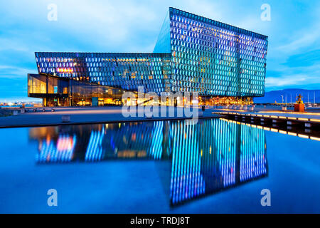 Beleuchtete Harpa Konzertsaal mit markanten farbigen Glas facace am Abend, Island, Reykjavik Stockfoto