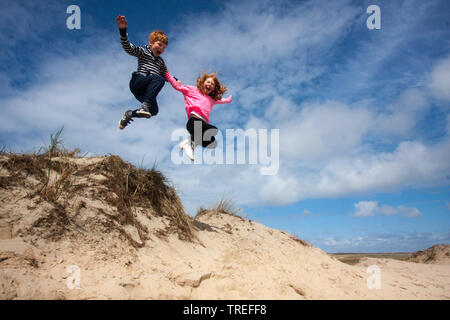 Springen die Kinder in den Dünen auf Texel, Niederlande, Texel, De Slufter Stockfoto