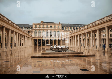 Gebäude und Innenhof mit modernen Skulptur an regnerischen Tag im Palais Royal in Paris. Einer der kulturellen Zentrum der eindrucksvollsten Welt in Frankreich. Stockfoto