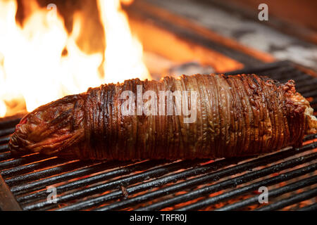 Türkische Street Food Kokorec Brötchen mit Lamm Darm rösten im Holzbackofen. Stockfoto