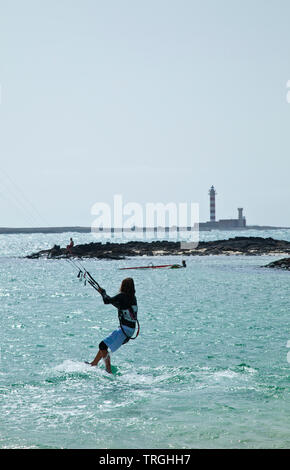 Kitesurf en Punta Willits. Al fondo El Faro de Tostón. Parque Natural de Corralejo. Isla Fuerteventura. Provinz Las Palmas. Islas Canarias. España Stockfoto