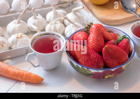 Erdbeere Obst mit Kaffee in keramik geschirr am Esstisch für Wochenende Stockfoto