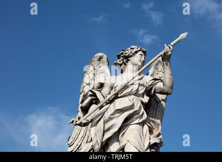 Die Marmorstatue der Engel mit dem Speer auf der Ponte Sant'Angelo. Die barocke Statue kann gegen einen tiefen blauen Sommerhimmel gesehen werden. Stockfoto