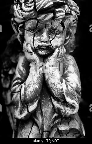 Alt und rissig Statue von Cherub Kind Stockfoto