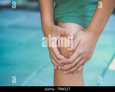 Kind Junge fühlen Knieschmerzen nach Spielen. gesund problem Konzept. Stockfoto