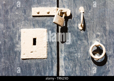 Alte Schlüsselloch, Verschluss mit Vorhängeschloss und Klopfer blauen Türen. Stockfoto
