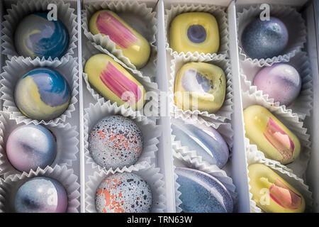 Eine Schachtel Pralinen in Pastellfarben sortiert Stockfoto